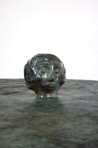 close-up of the Her side table by Elizabeth Garouste in green bronze