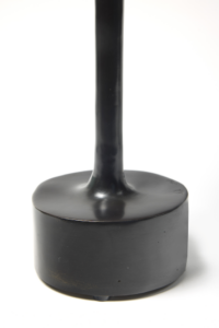 Close-up of the black bronze base of Mattia Bonetti's Cobra lamp, a round base from which a straight stem extends