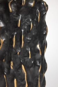 Close-up of Elizabeth Garouste's Rainy Day lamp, in black and gold bronze, like golden raindrops, flowing down the black bronze